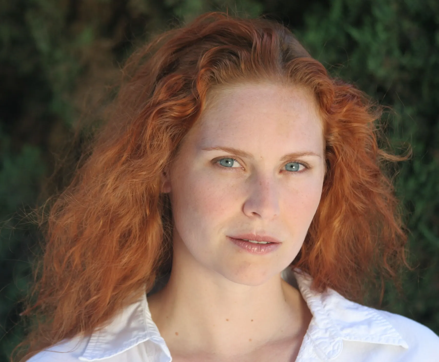 Woman with red hair photographed in soft outdoor light